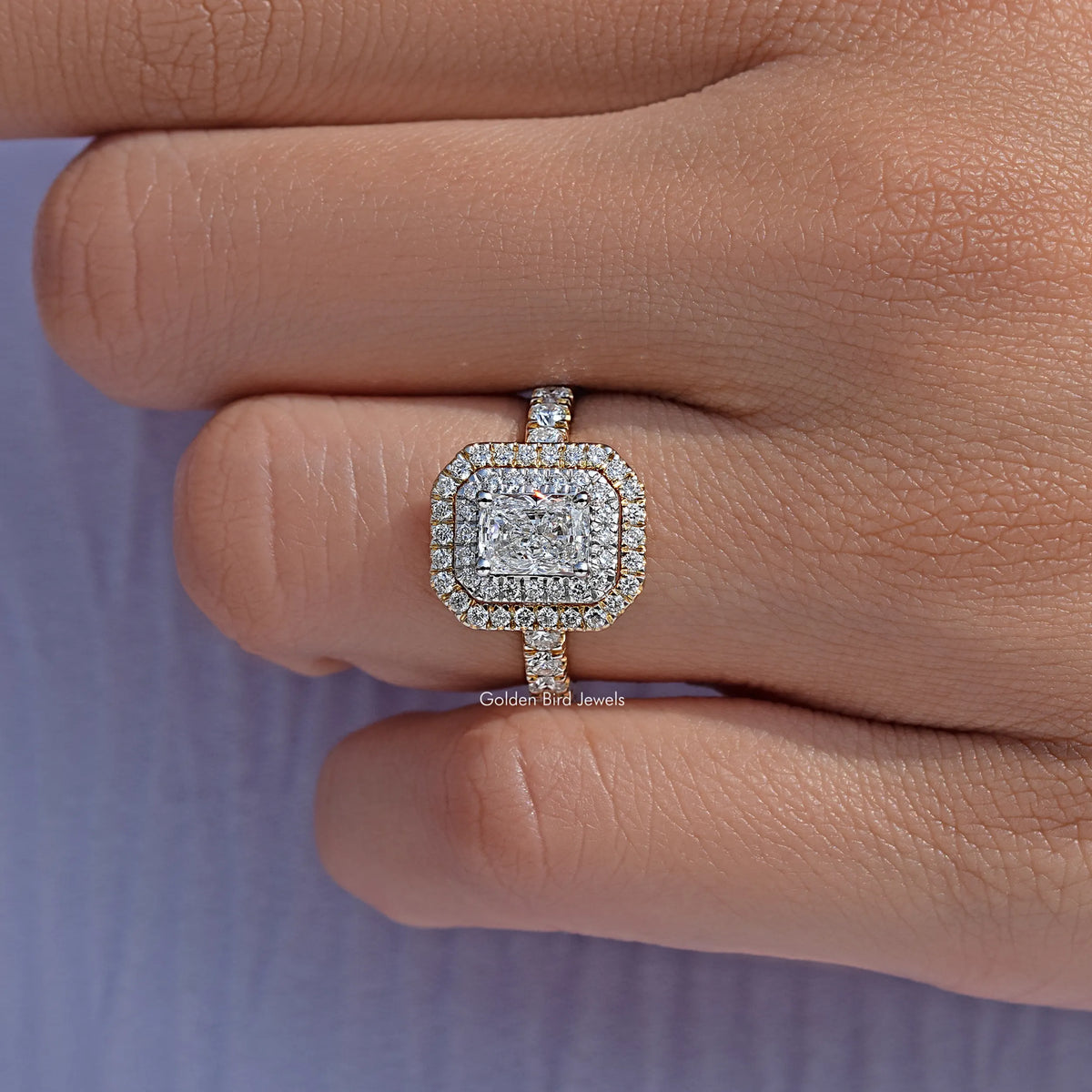 Radiant cut diamond double halo engagement ring on a finger