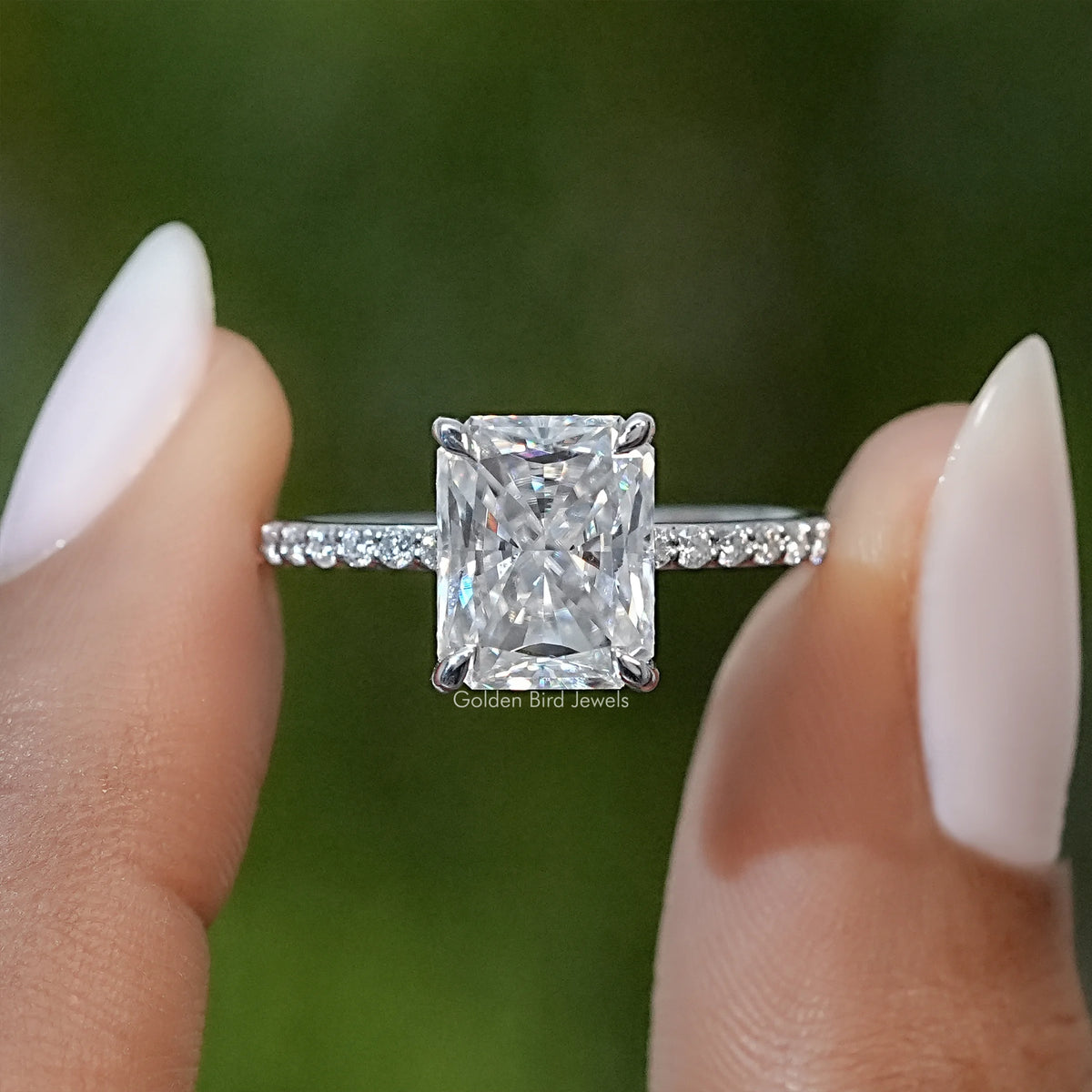 Sterling silver solitaire ring with radiant cut square moissanite center and side accents