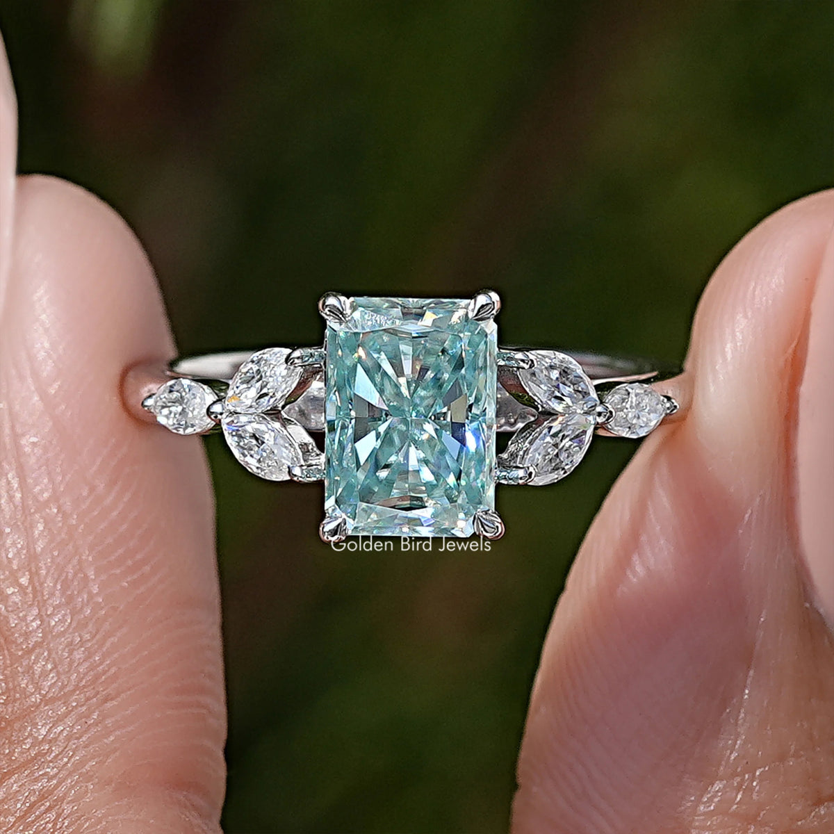 Sterling silver radiant moissanite ring with cushion-cut center and pear-side stones