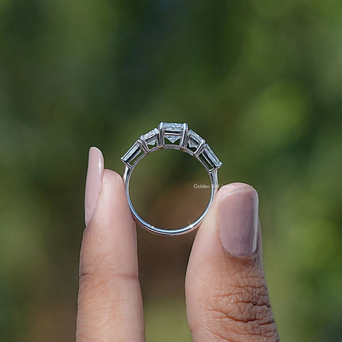 Back View of Radiant Cut And Tapered Baguette Cut Five Stone Ring In two fingers