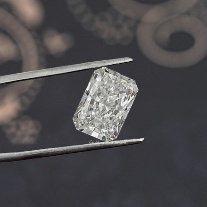 Radiant cut lab-grown diamond close-up with tweezers, angled view