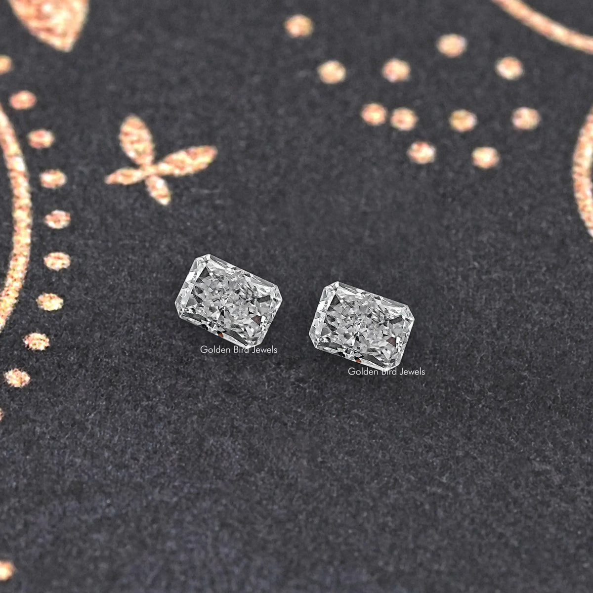 Radiant-cut loose diamond pair, two clear faceted rectangular stones in an angled view.