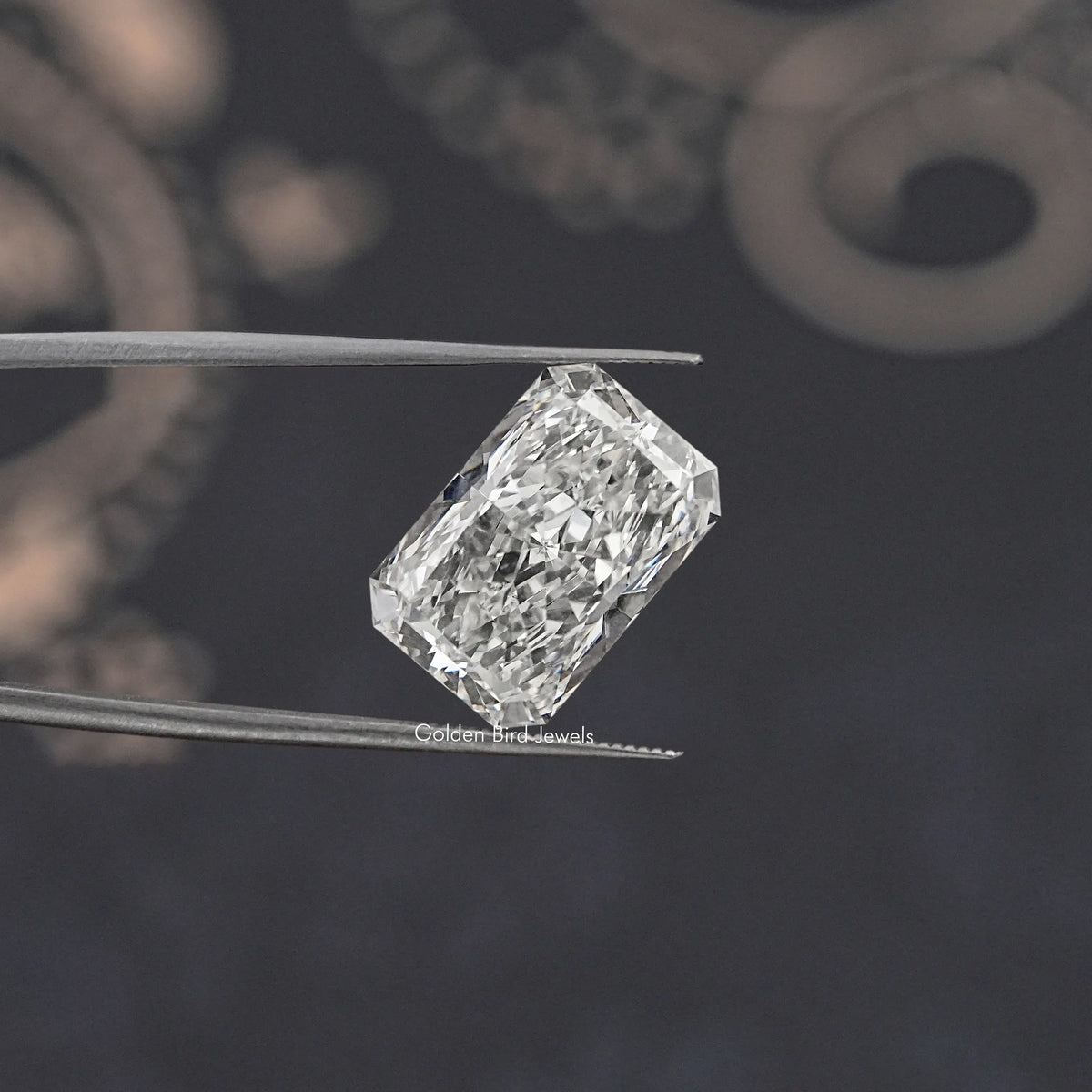 Radiant-cut loose lab diamond held in tweezers, clear white stone