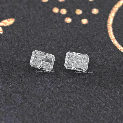 Radiant-cut loose diamond pair, matching clear rectangular stones shown from front.