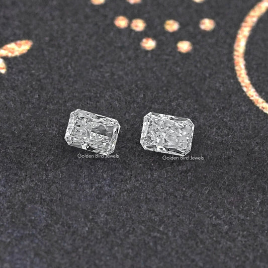 Radiant-cut loose diamond pair, matching clear rectangular stones shown from front.