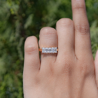 Five-stone moissanite radiant-cut ring on finger, clear stones across the band