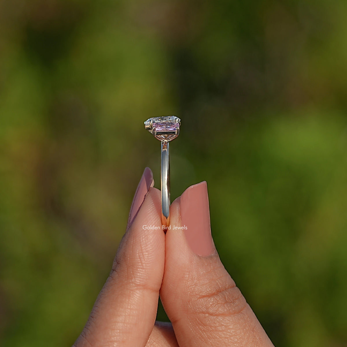 Rose gold-tone two-stone ring with oval center diamond and pink princess-cut gem