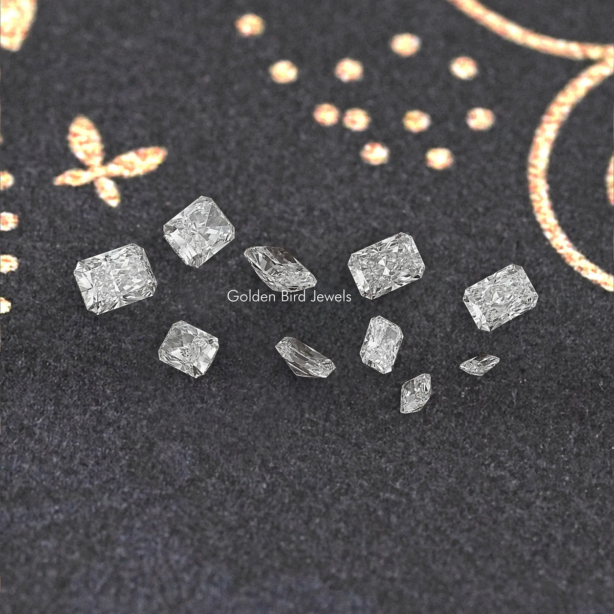 Loose radiant-cut lab diamonds scattered on dark fabric, clear facets