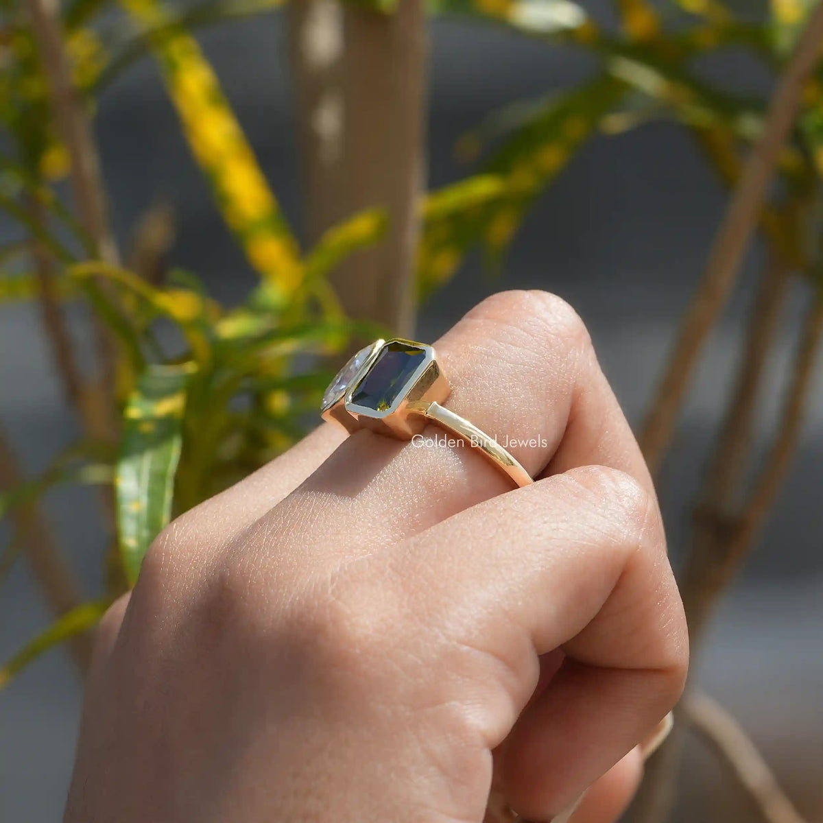 Side View of Bezel Set Radiant And Pear Cut Moissanite Ring In finger