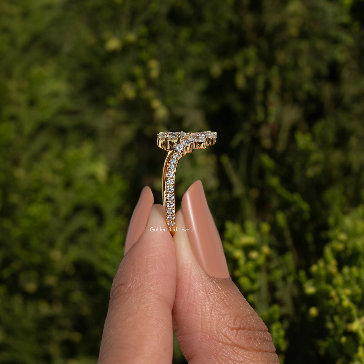 Rose cut round moissanite curved engagement ring in gold-tone, side view on a finger