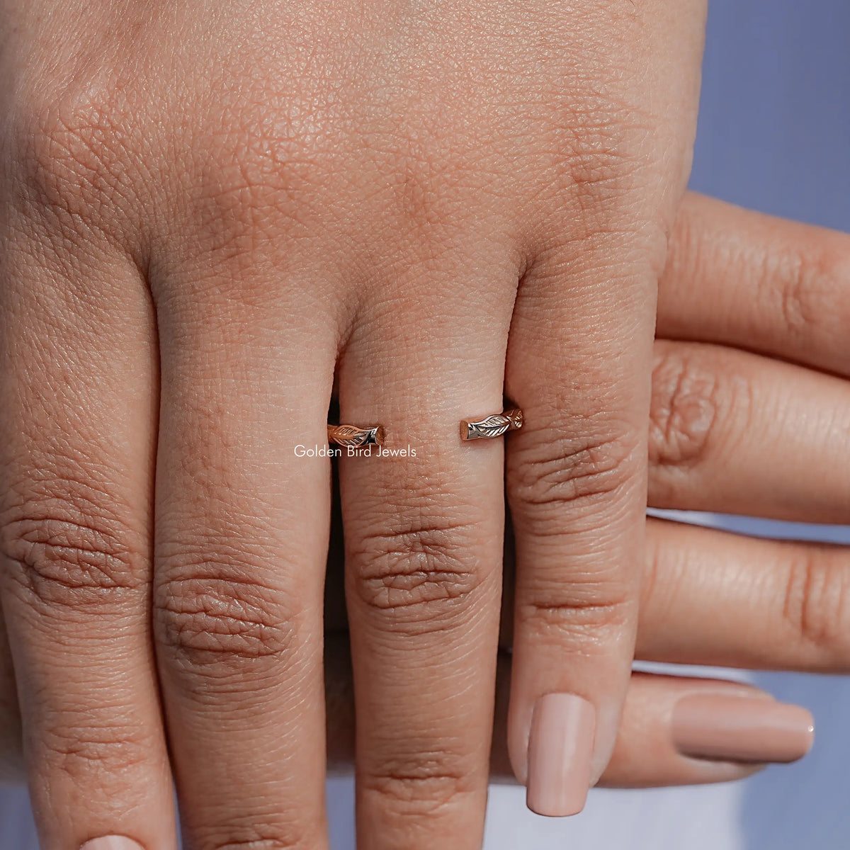 Leaf motif open cuff ring on fingers, showing the band on hand