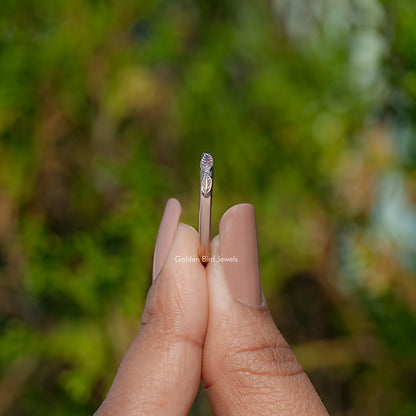 Open cuff ring profile with engraved leaf detail shown on fingertips