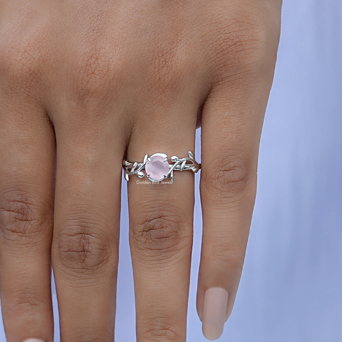 Leaf-style rose quartz gemstone ring, silver band, worn on finger