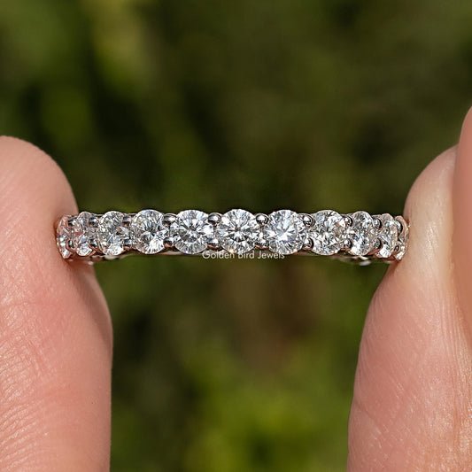 Round moissanite eternity wedding band in 925 sterling silver, side view of stones
