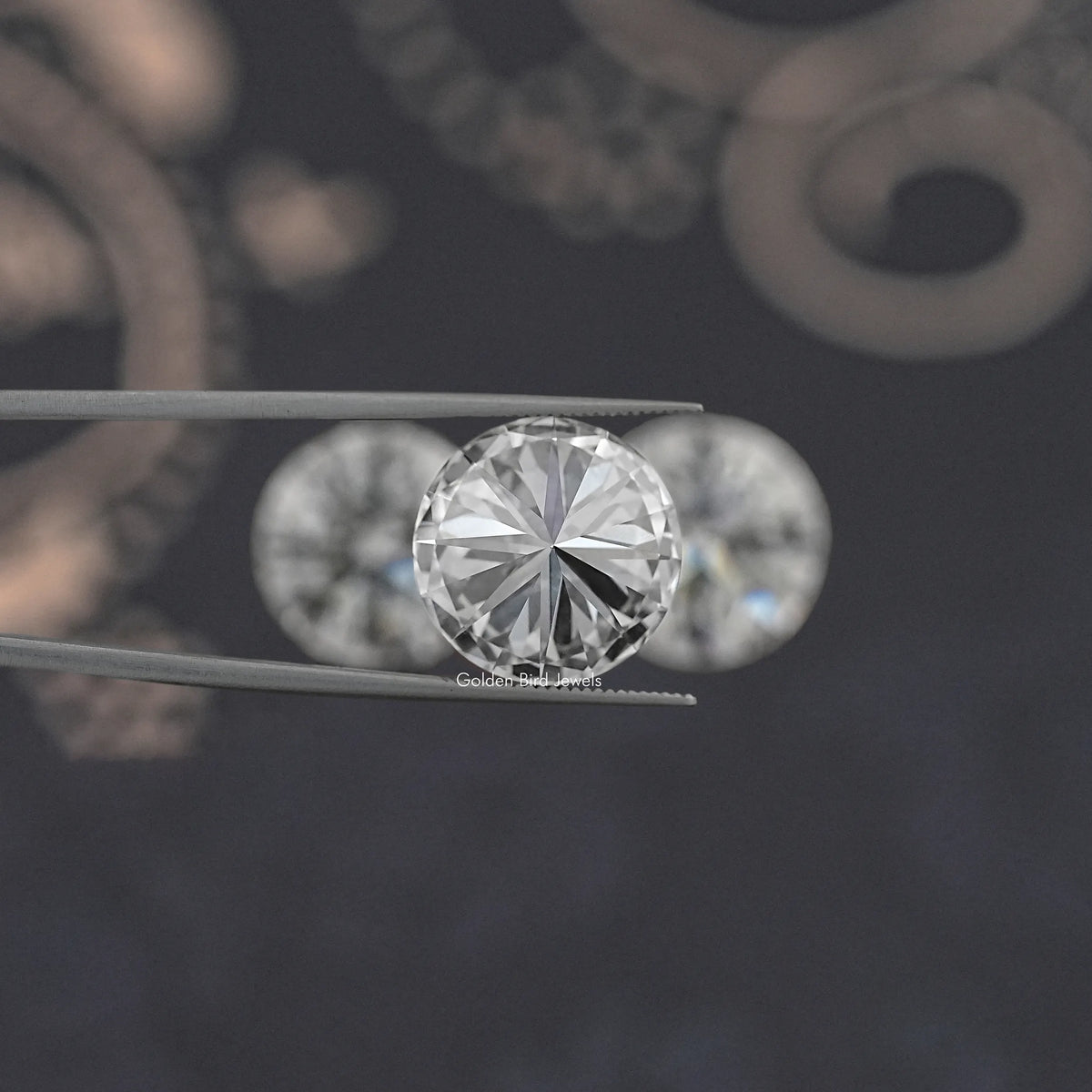 Round-cut lab-grown diamond close-up held between metal tweezers