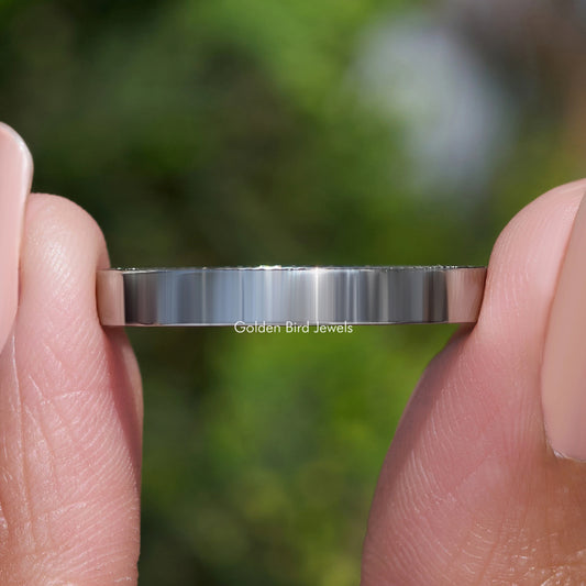 Silver-tone channel-set ring band with small round stones, close-up front edge