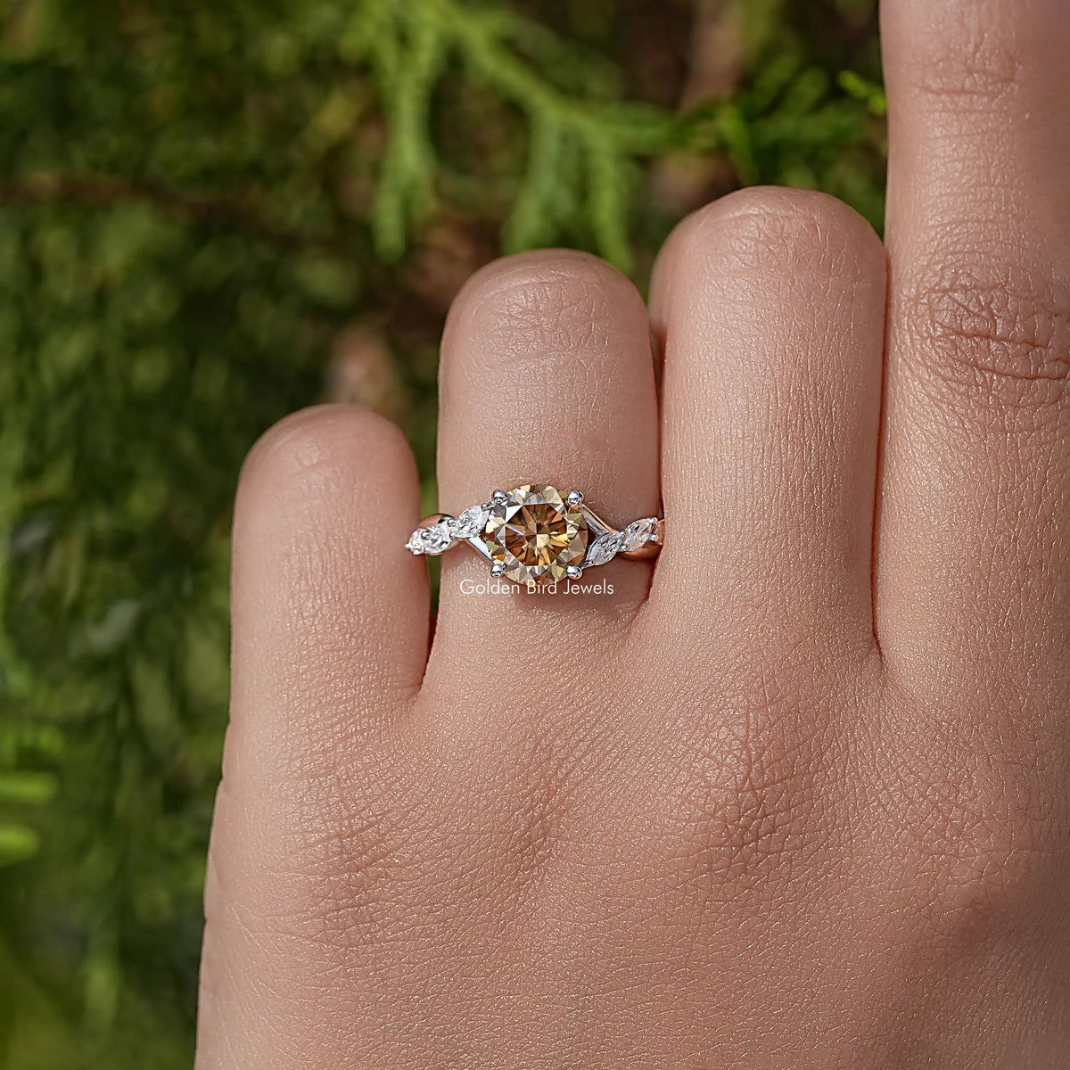Floral sterling silver wedding ring with round yellow moissanite center on finger