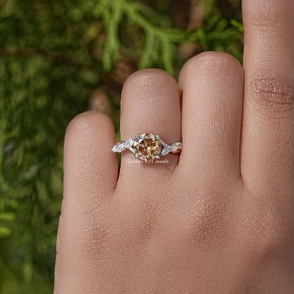 Floral sterling silver wedding ring with round yellow moissanite center on finger