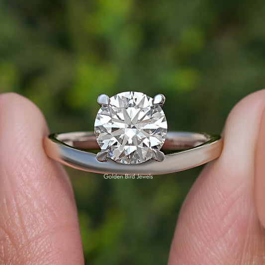 Silver curved solitaire ring featuring round lab diamond with multi-prong setting