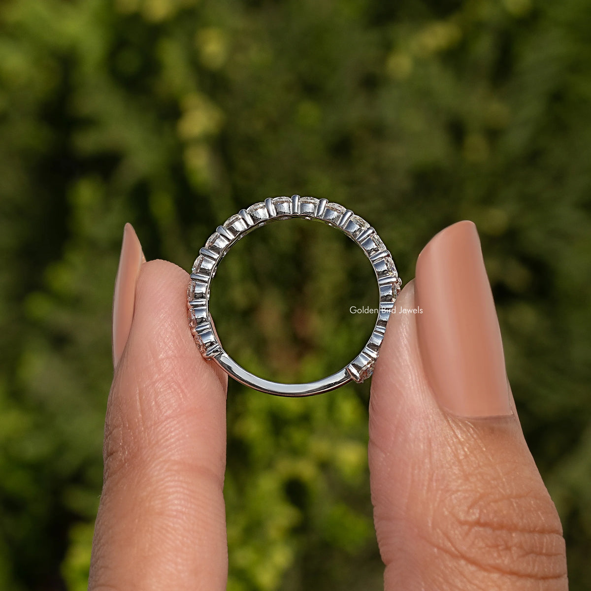 Round cut moissanite eternity band in 925 sterling silver, circular row of stones
