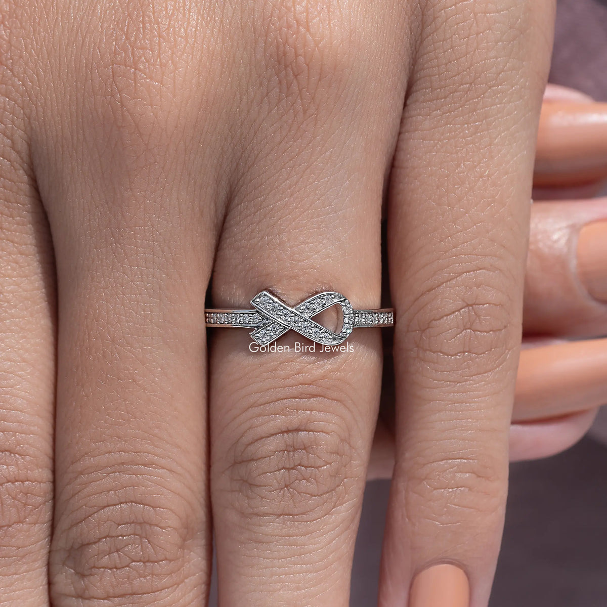 Moissanite ring with ribbon X design, round-cut stone band, silver tone
