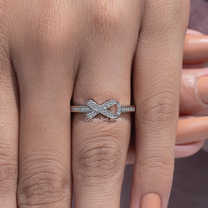 Moissanite ring with ribbon X design, round-cut stone band, silver tone