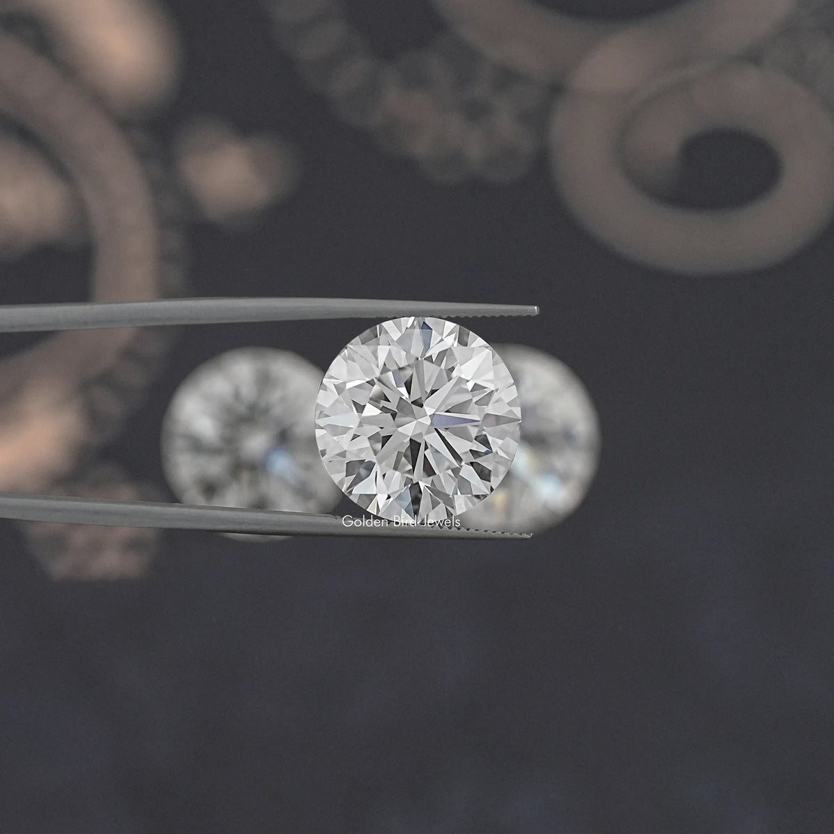 Round-cut lab-grown diamond held between metal tweezers