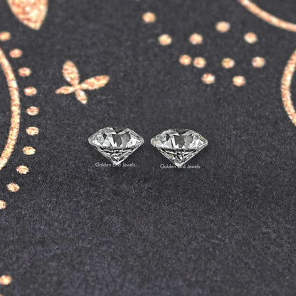 Matching stud earrings with two round old European diamonds, side view