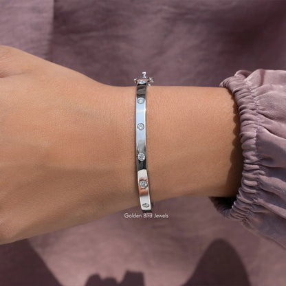 Silver bangle with round lab diamonds, flush-set row along the top edge