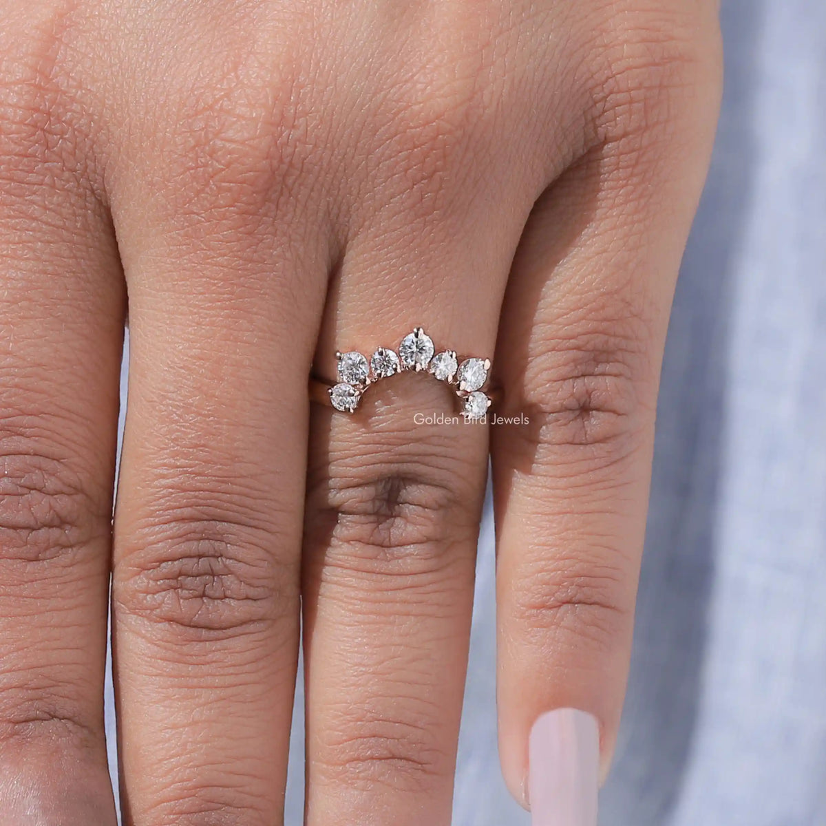 Curved stacking wedding band with five round diamonds across the top