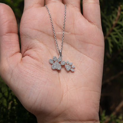 Silver-tone chain necklace with paw-cluster pendant, round-cut sparkling stones on palm