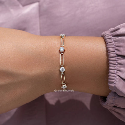 Gold-tone round-cut stone link bracelet on wrist with multiple sparkle stations