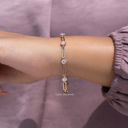 Gold-tone moissanite link bracelet with round-cut stones on wrist