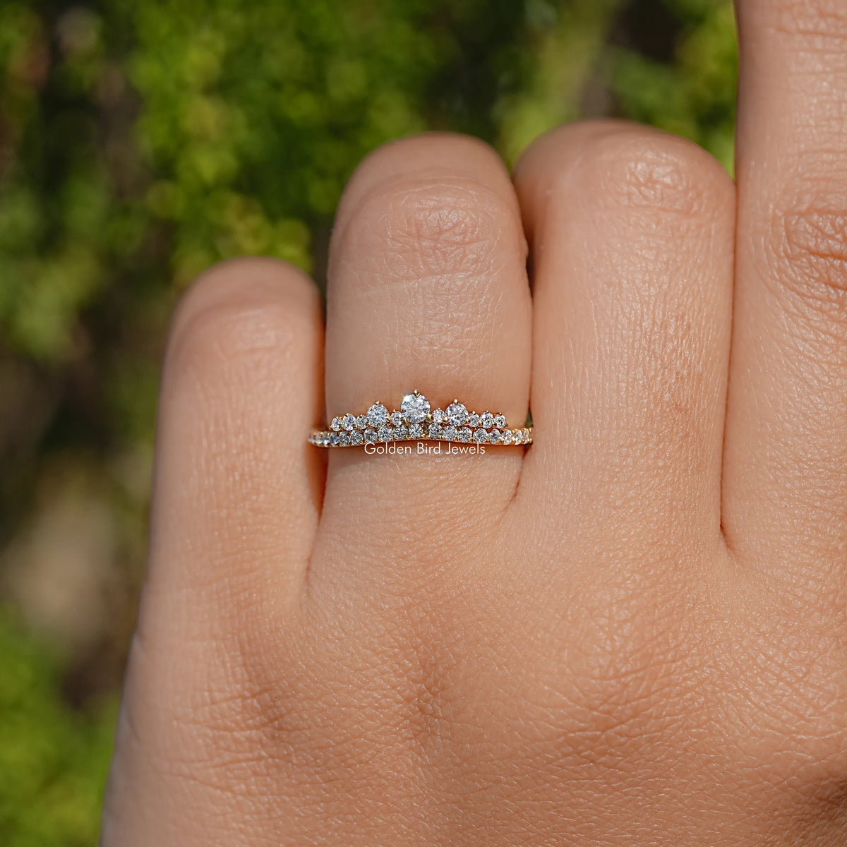 Slim moissanite band ring with evenly spaced round stones, silver-tone, on finger