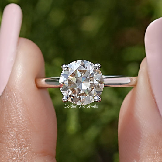 Sterling silver round-cut moissanite solitaire ring close-up, prongs and band