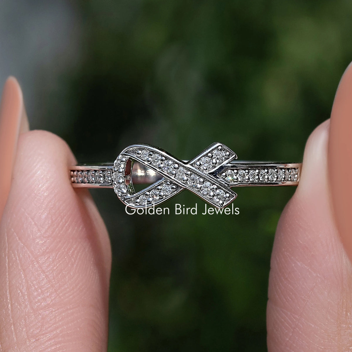 Moissanite ribbon-style round cut ring with pavé crossover band