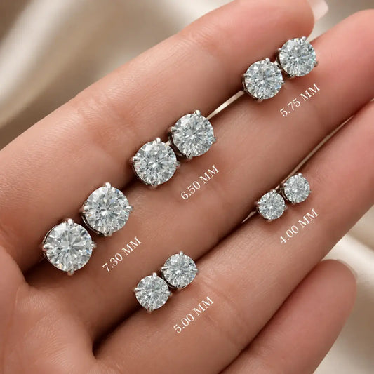 Round moissanite stud earrings with round stones on prong settings; labeled 7.30–4.00 mm.