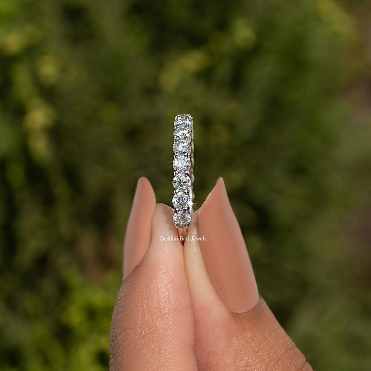 925 sterling silver ring with a straight row of round moissanite stones