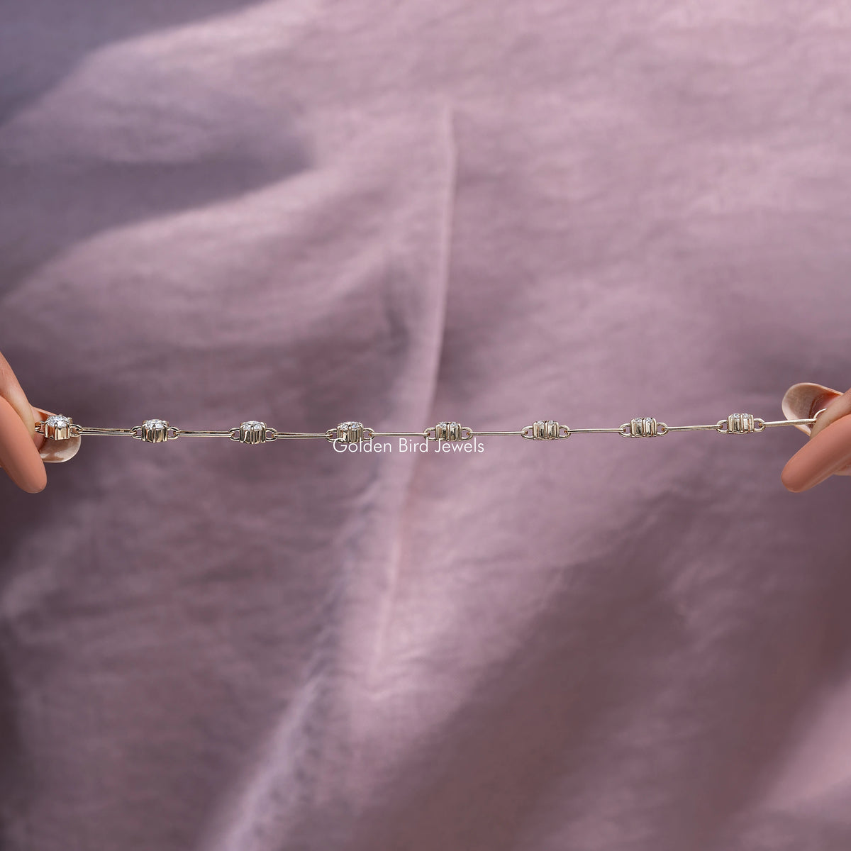Gold-tone link bracelet laid flat, featuring round-cut moissanite-style stones