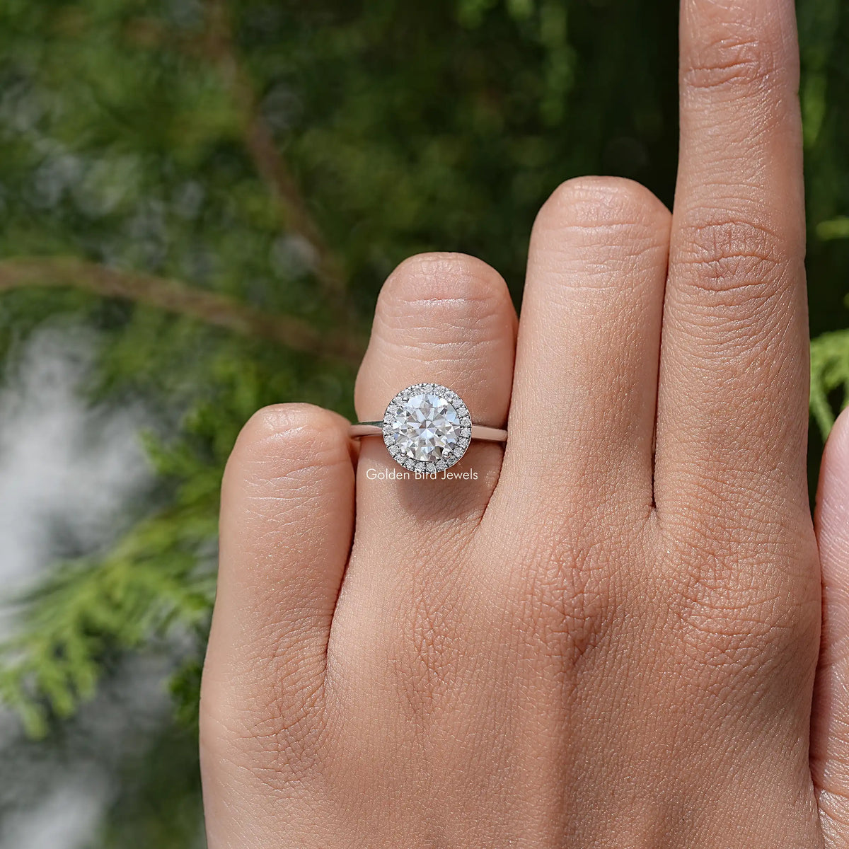 Round halo moissanite promise ring on finger, 925 sterling silver