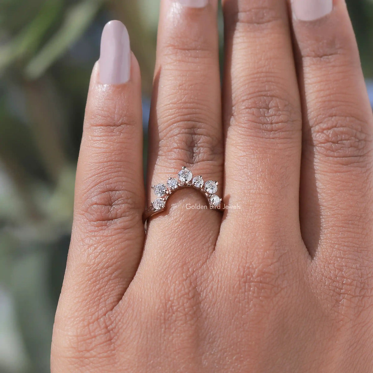 Curved stacking wedding band with round diamonds in a wave setting