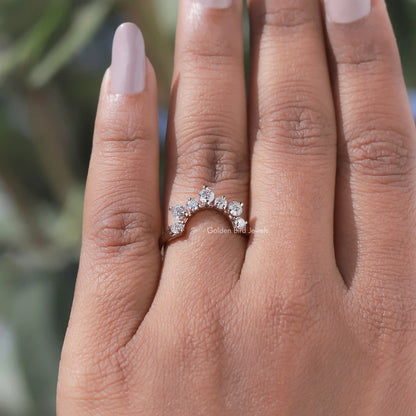 Curved stacking wedding band with round diamonds in a wave setting