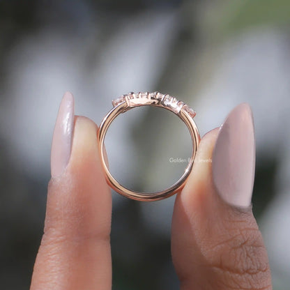 Rose-gold tone curved band with small round diamonds in an open setting