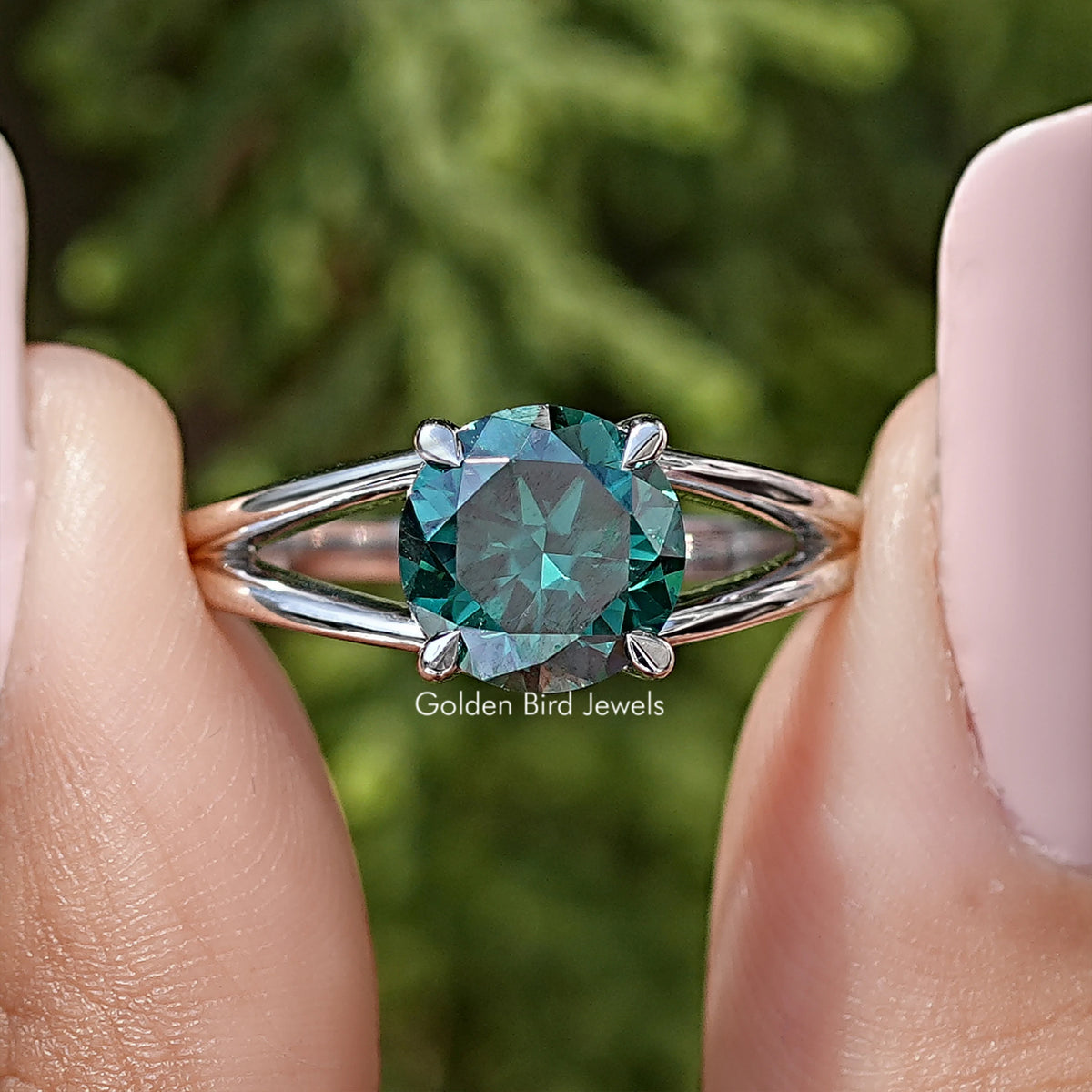 Sterling silver split-shank engagement ring with round teal moissanite center stone