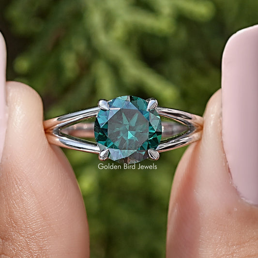 Sterling silver split-shank engagement ring with round teal moissanite center stone