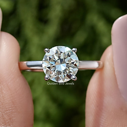 Round moissanite center stone with small halo stones on sterling silver band