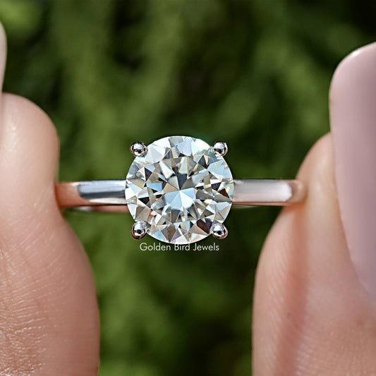 Round moissanite center stone with small halo stones on sterling silver band