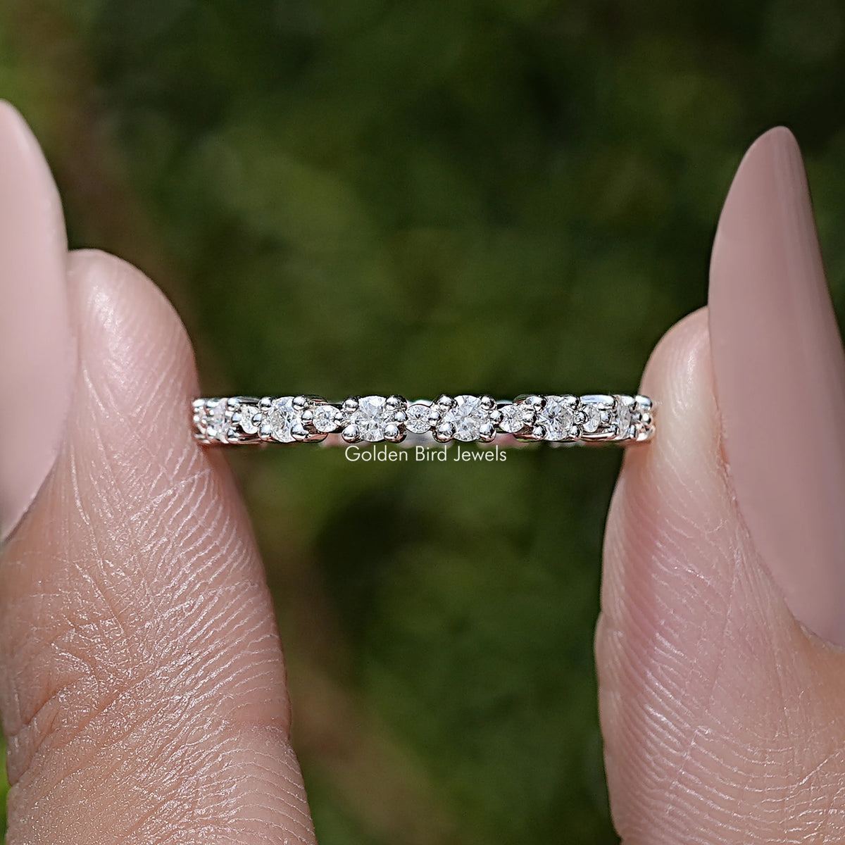 Silver full eternity wedding band with round moissanite stones in a straight row