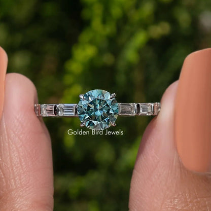 Sterling silver ring with round blue-green moissanite center and baguette side stones