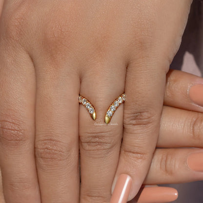 Gold open V-shape wedding band with round-cut stones, centered on fingers